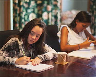 Two young writers at a table