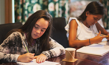 Two young writers at a table